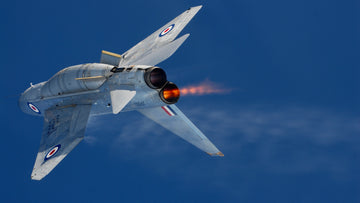 Military jet in flight against a blue sky