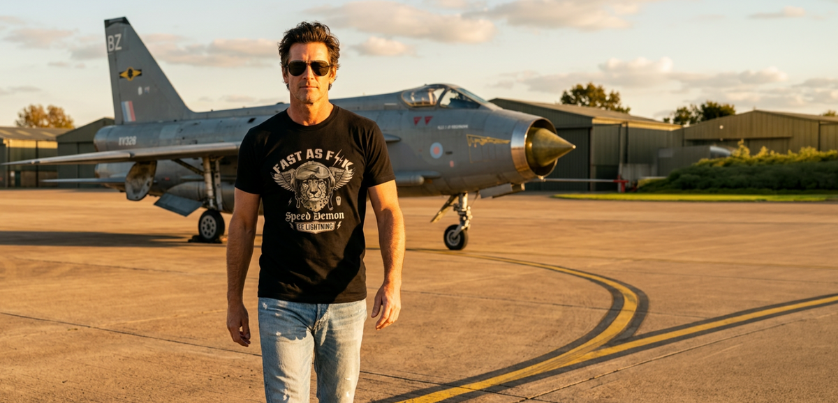 Man walking on a tarmac with a fighter jet in the background wearing a cool aviation t shirt.1621243260e1af0c20-2